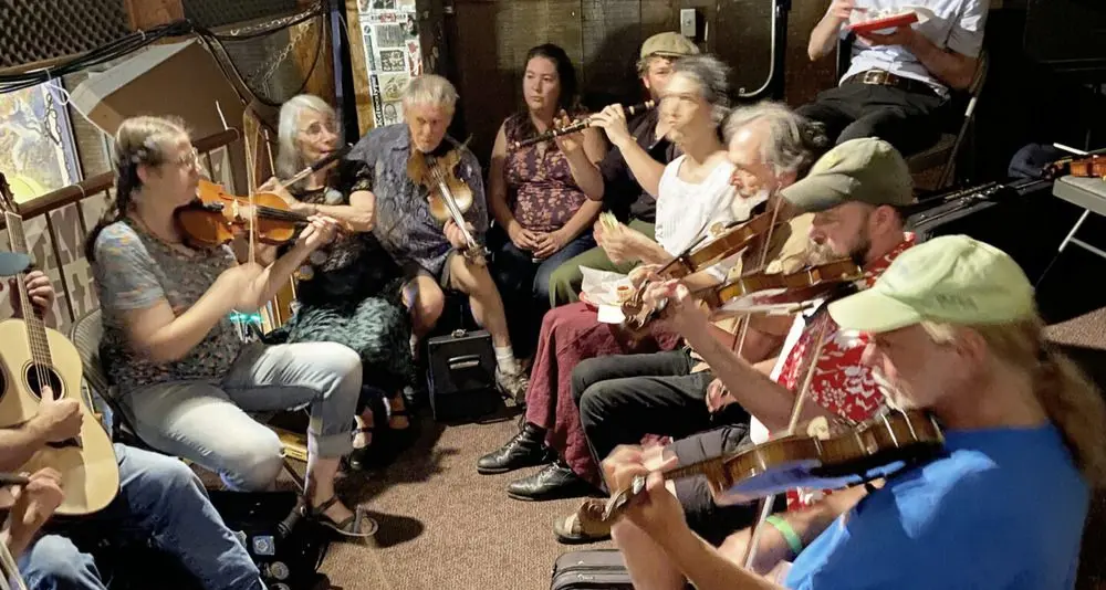 people playing at an indoor celtic music jam session